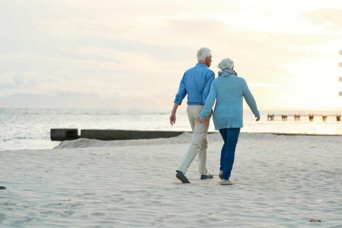 senior couple walking on the beach